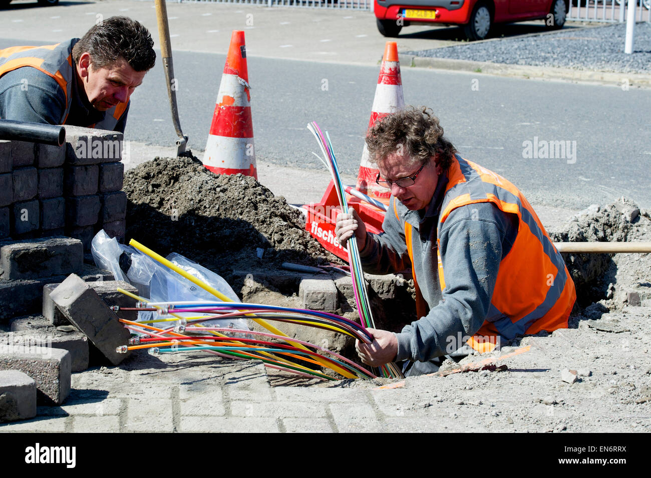 Men laying optical fiber cables Stock Photo Alamy
