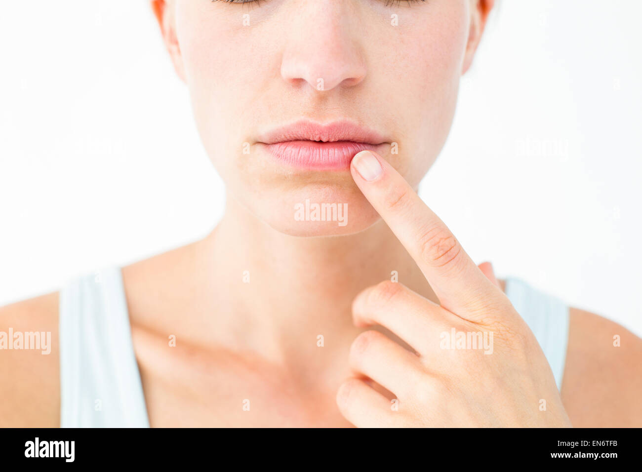 Pretty woman with finger on lip Stock Photo