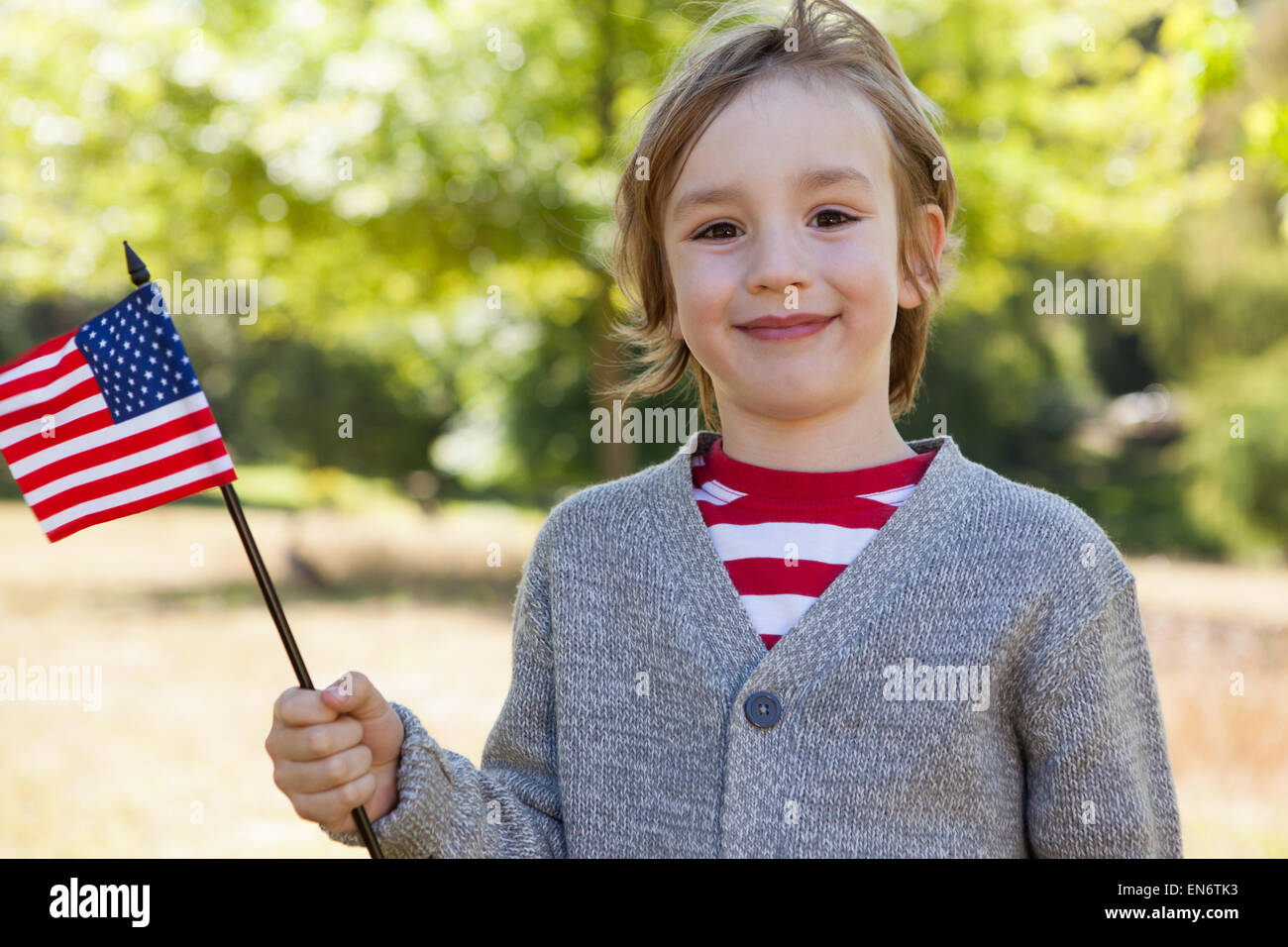 Cute little boy waving american flag Stock Photo