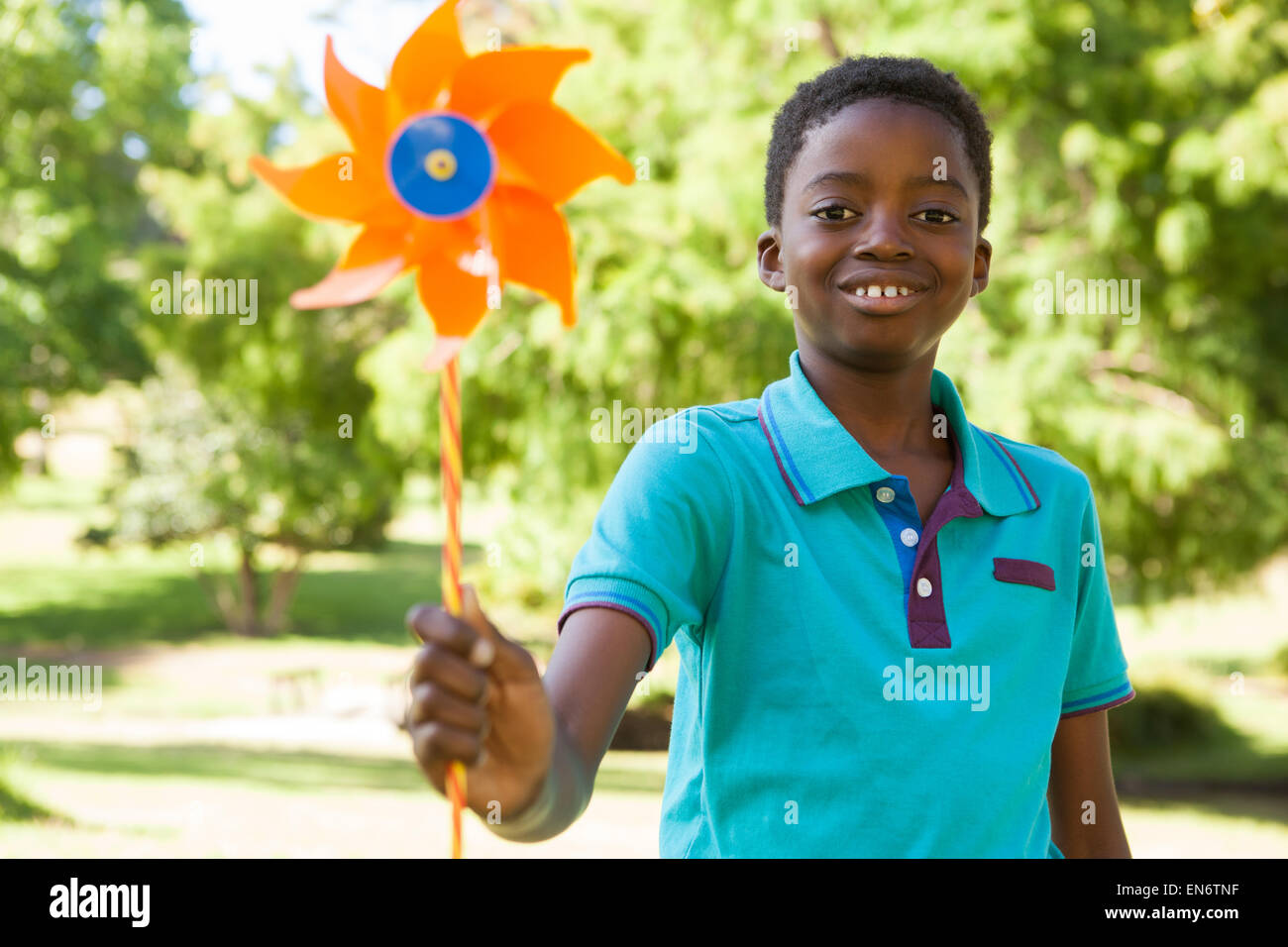 Happy boy in the park with pinwheel Stock Photo - Alamy