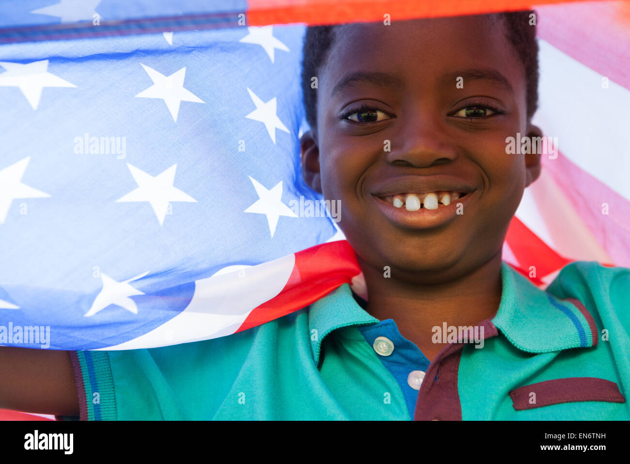 Happy boy in the park with american flag Stock Photo