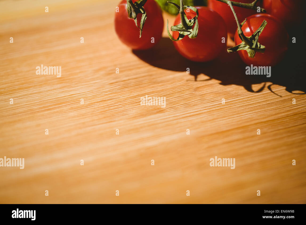 Cherry tomatoes on chopping board Stock Photo - Alamy