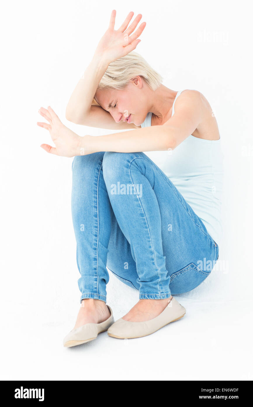 Scared woman protecting herself Stock Photo