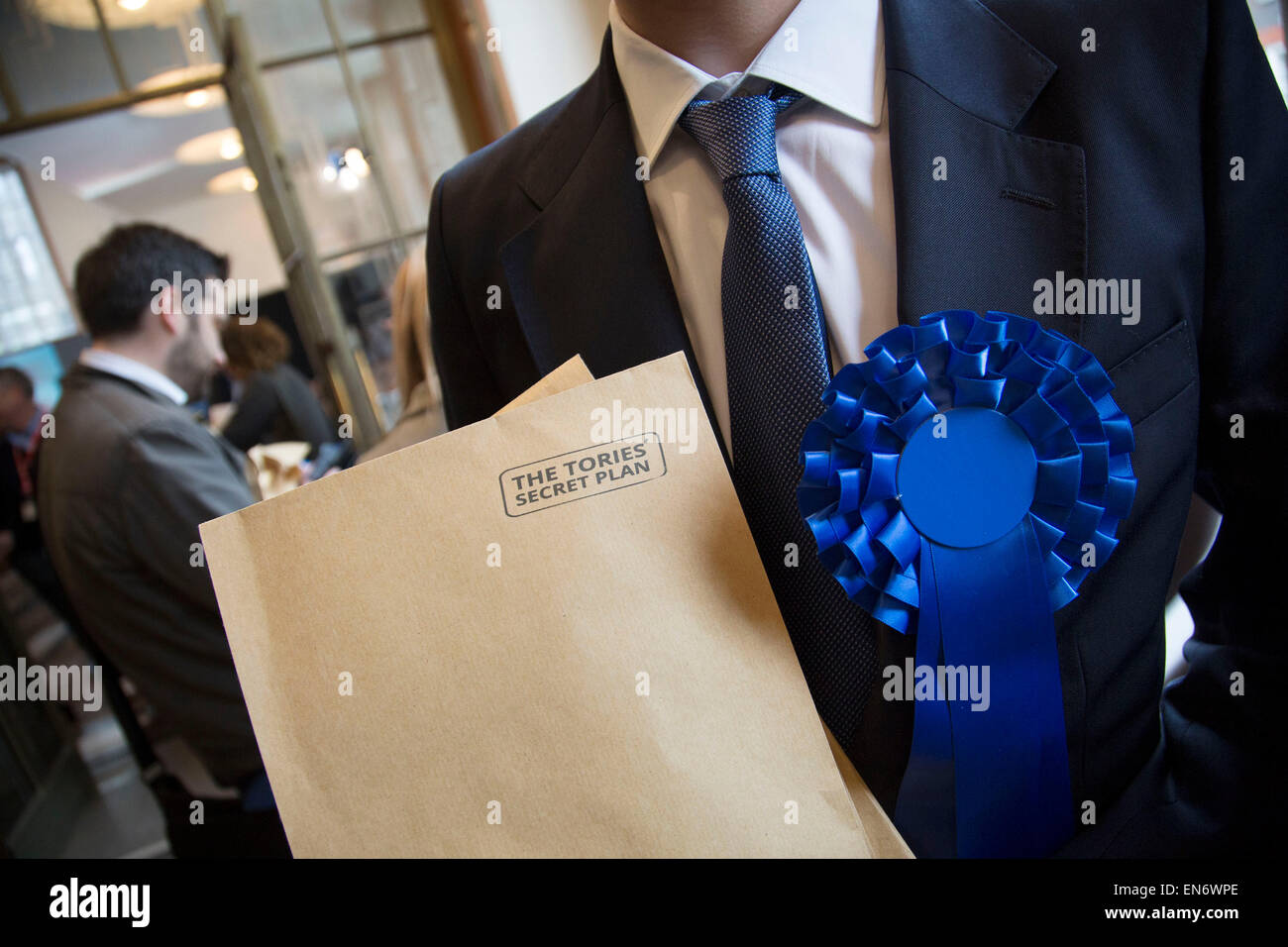 London, UK. Wednesday 29th April 2015. Labour Party member and supporter with a fake Tory dossier at a General Election 2015 campaign event on the Tory threat to family finances, entitled: The Tories’ Secret Plan. Held at the Royal Institute of British Architects. Credit:  Michael Kemp/Alamy Live News Stock Photo