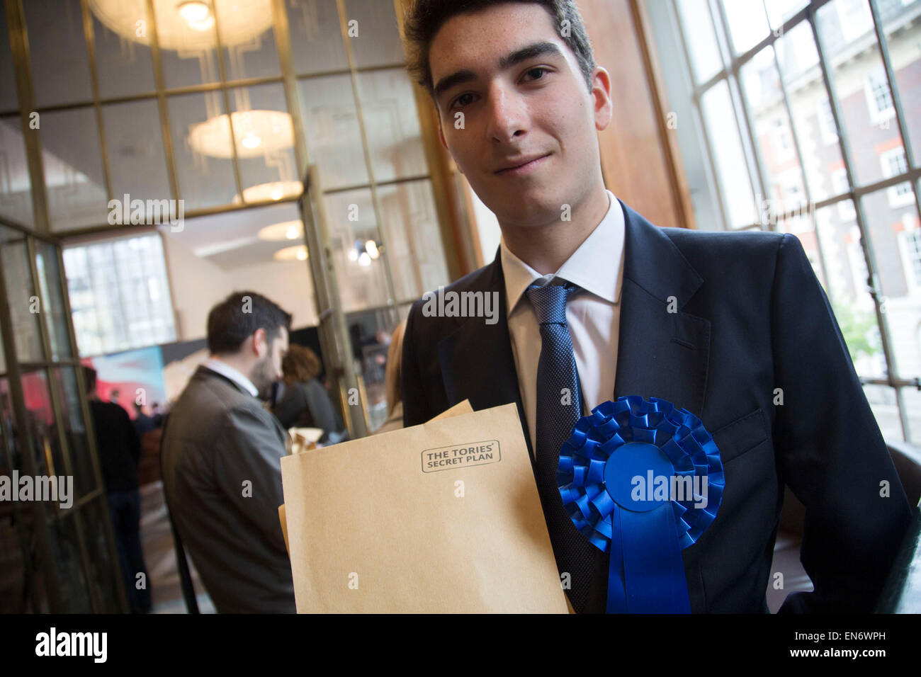 London, UK. Wednesday 29th April 2015. Labour Party member and supporter with a fake Tory dossier at a General Election 2015 campaign event on the Tory threat to family finances, entitled: The Tories’ Secret Plan. Held at the Royal Institute of British Architects. Credit:  Michael Kemp/Alamy Live News Stock Photo