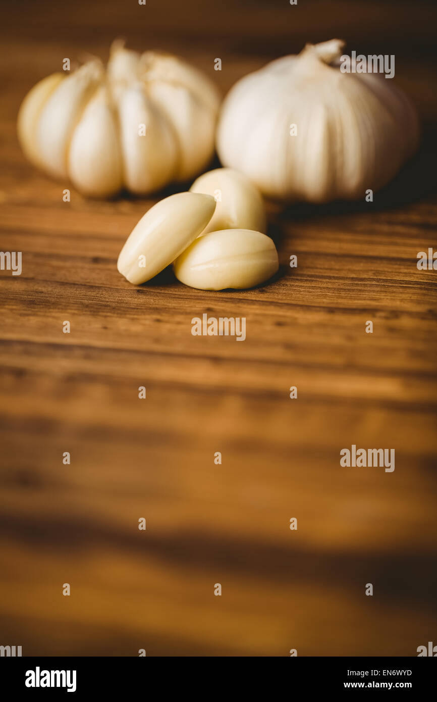 Garlic cloves and bulb on chopping board Stock Photo - Alamy