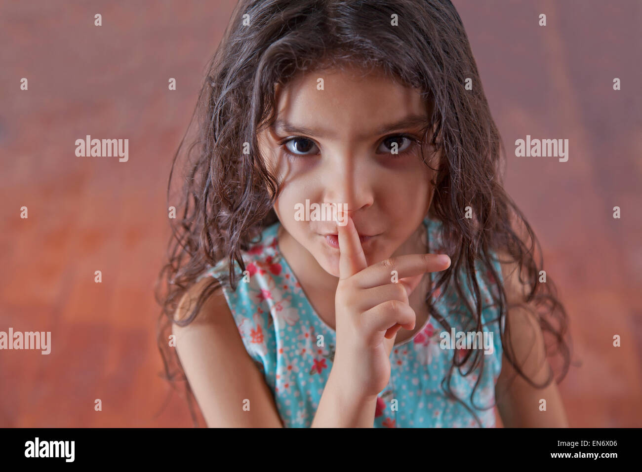 Portrait of girl with finger on lips Stock Photo - Alamy