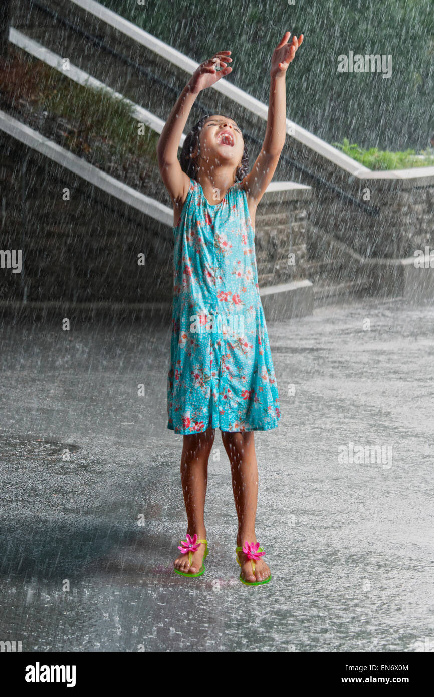 Little girl playing in the rain Stock Photo Alamy