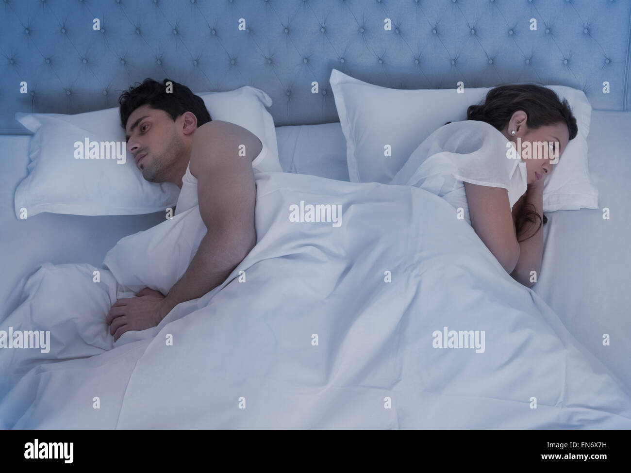 Angry couple in bed Stock Photo