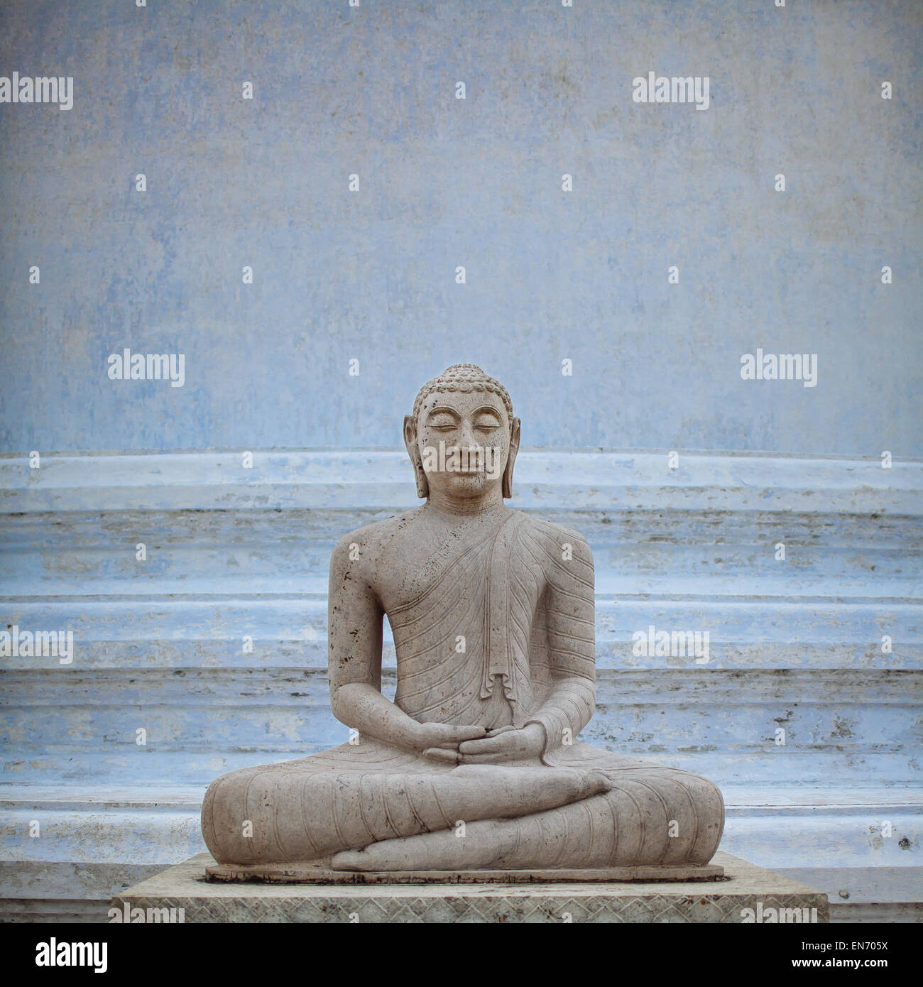 A Buddha statue at the base of Mirisavatiya dagoba in the ancient city of Anuradhapura, Sri Lanka. Stock Photo