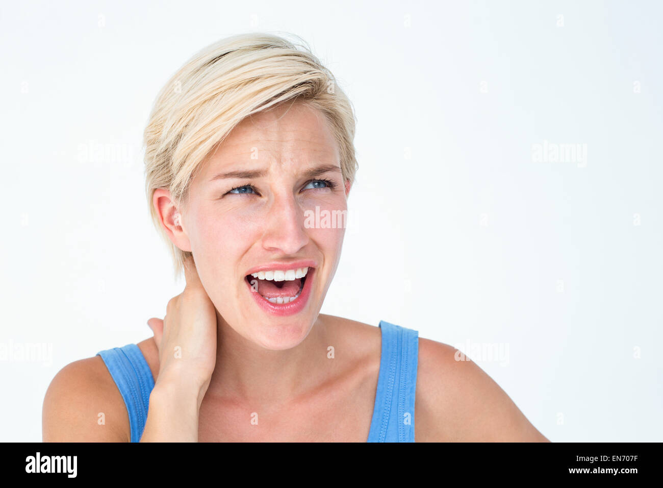 Woman screaming and suffering from neck pain Stock Photo Alamy