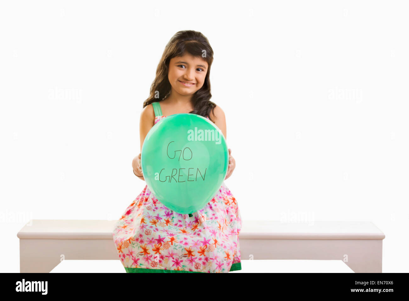 Girl holding green balloon hi-res stock photography and images - Alamy