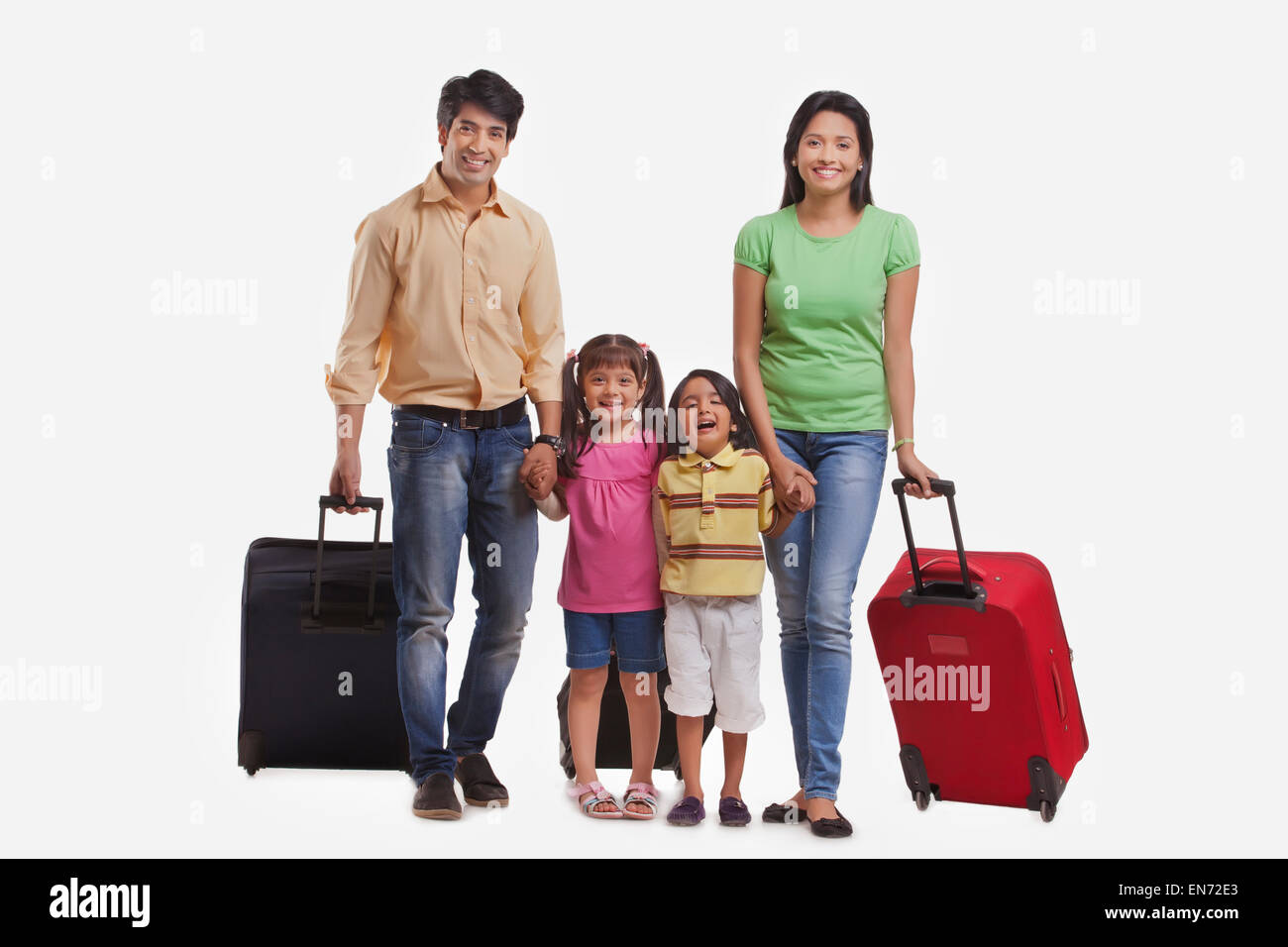 Portrait of family with suitcases Stock Photo
