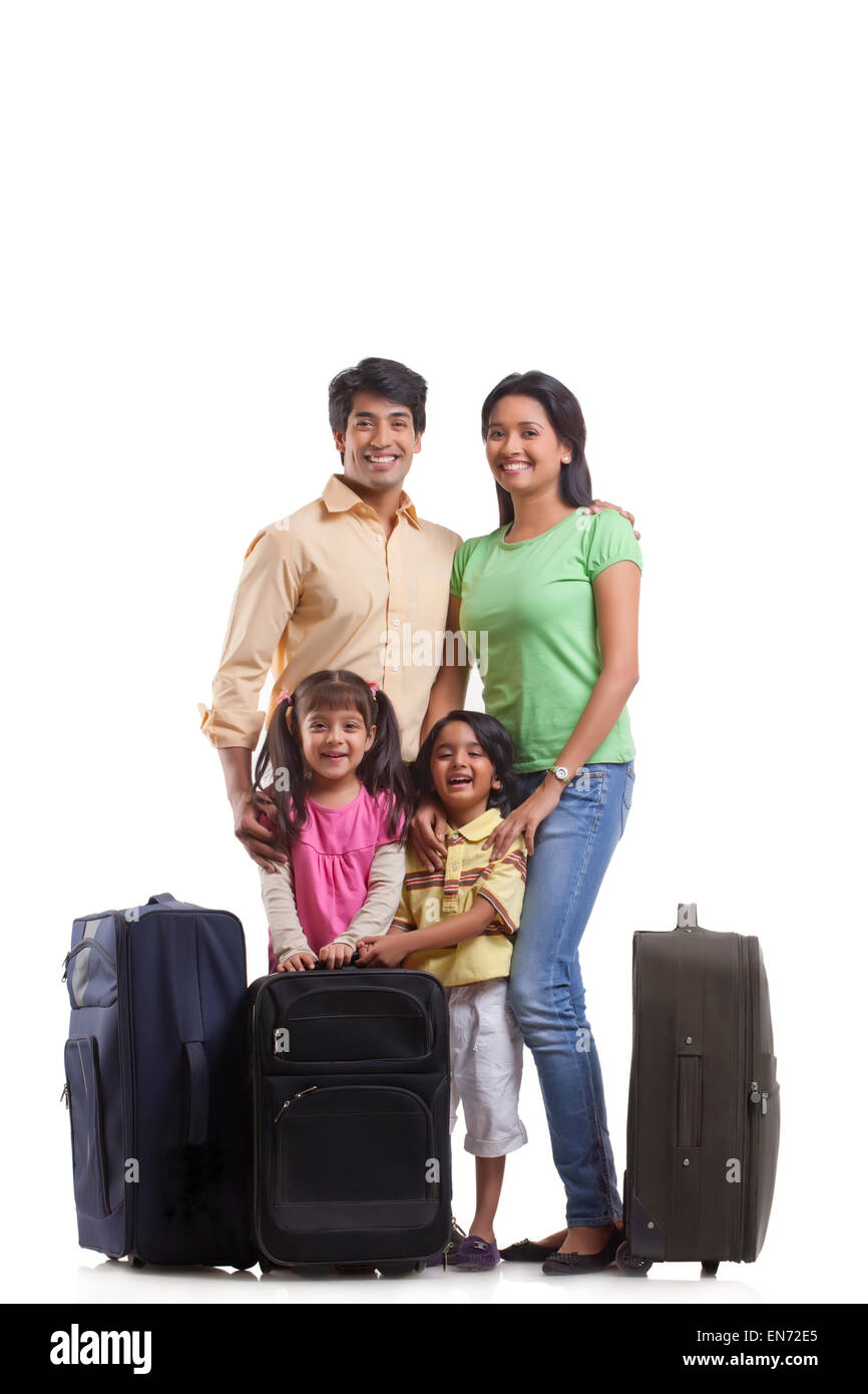 Portrait of family with suitcases Stock Photo