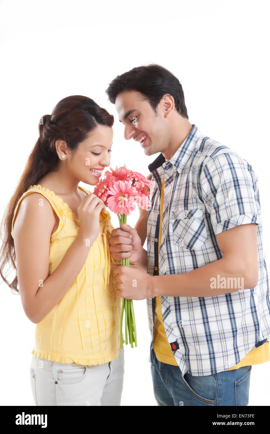 Indian man giving flowers to woman hi-res stock photography and images ...