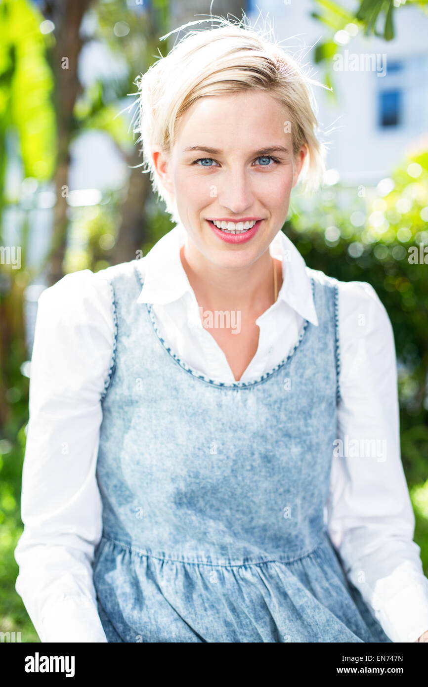 Pretty blonde woman smiling at the camera Stock Photo - Alamy
