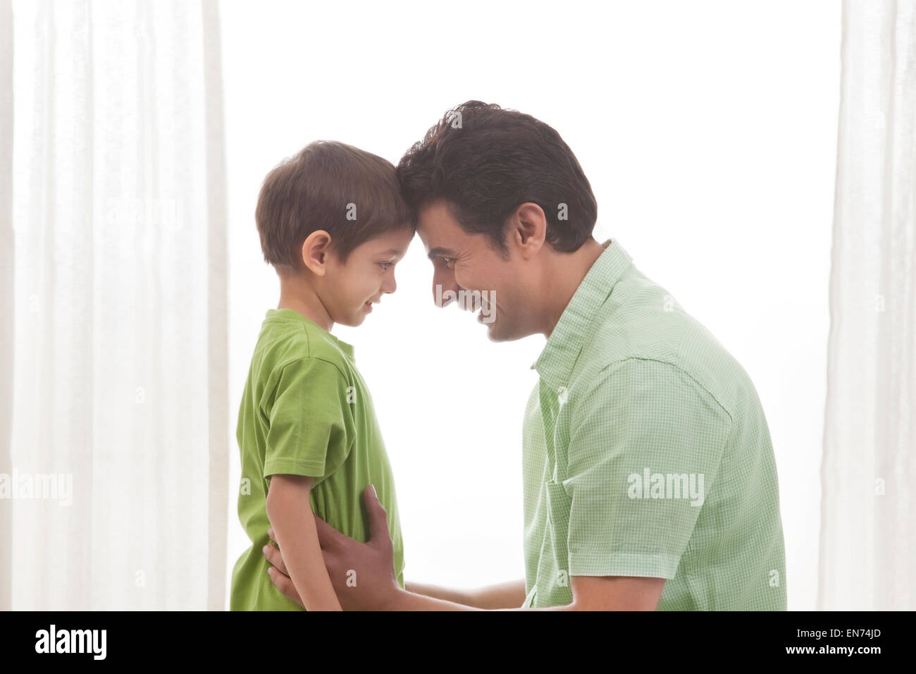 Father and son face to face smiling Stock Photo