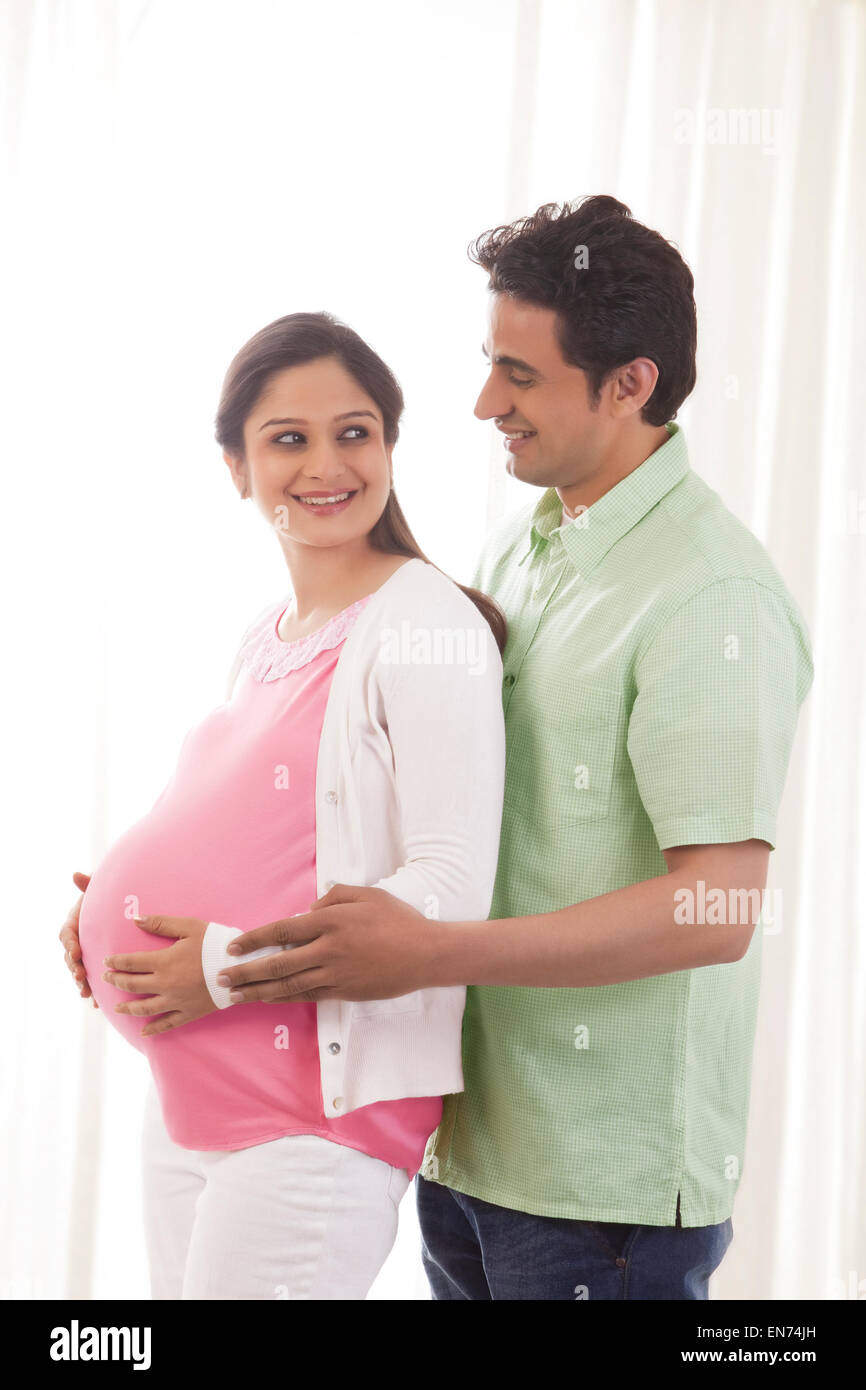 Man embracing pregnant woman Stock Photo - Alamy