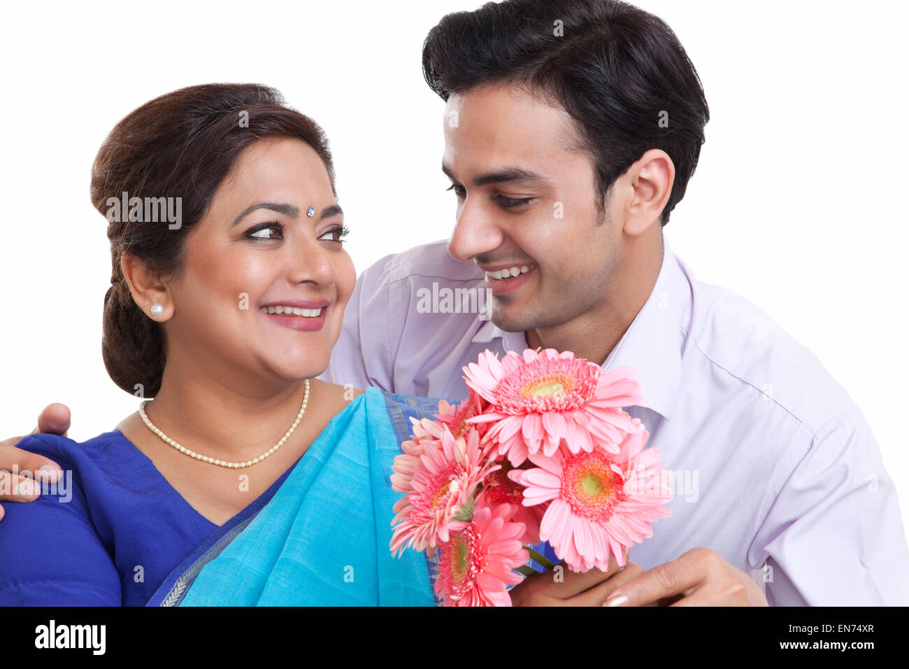 Son giving his mother flowers Stock Photo Alamy