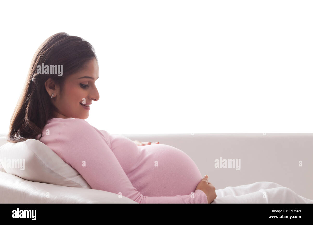 Pregnant woman looking at her stomach Stock Photo