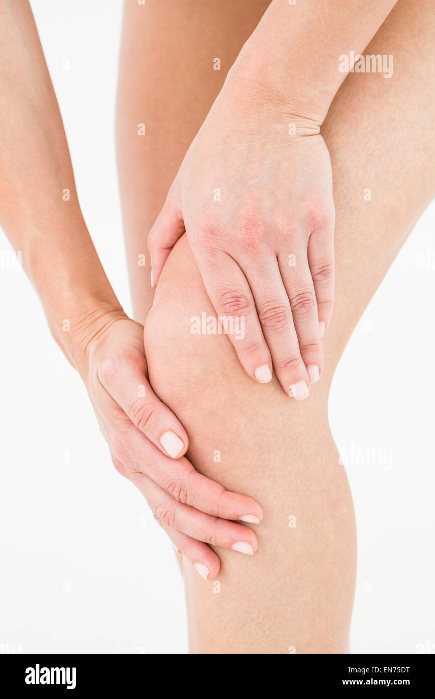 Natural woman touching her painful knee Stock Photo