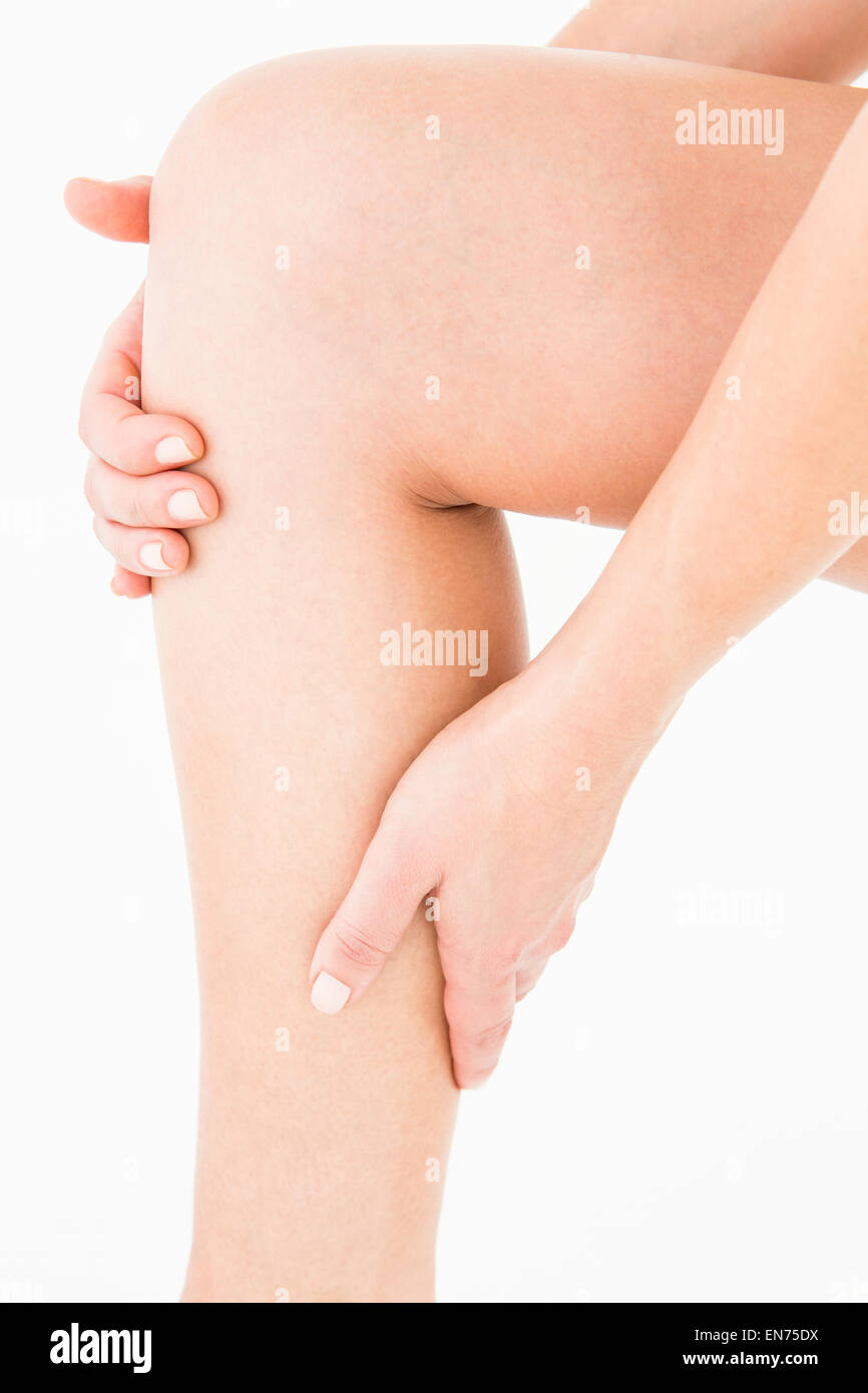 Natural woman touching her painful leg Stock Photo