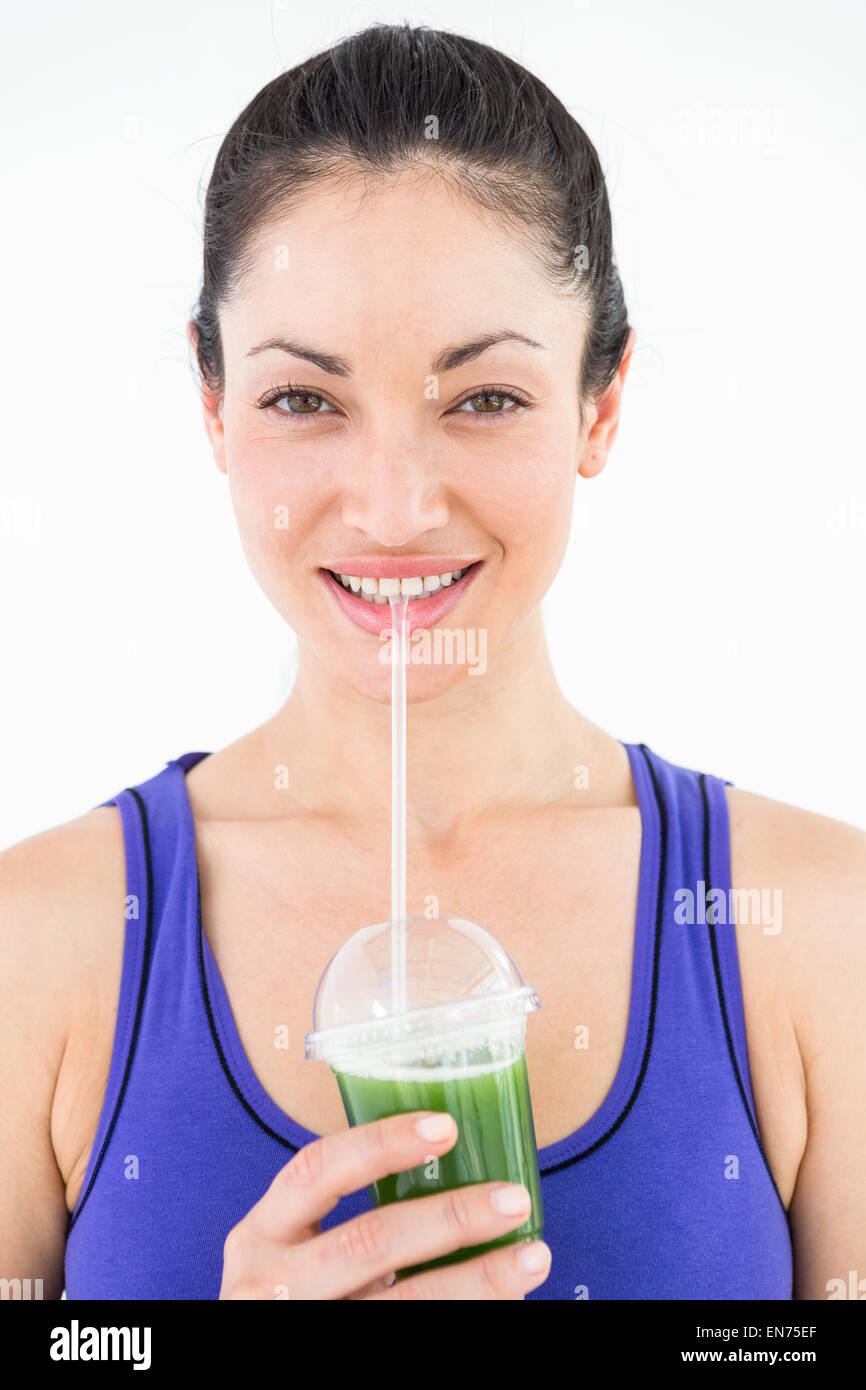 Beautiful woman drinking green juice Stock Photo Alamy