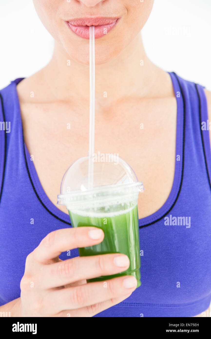 Attractive woman drinking green juice Stock Photo Alamy