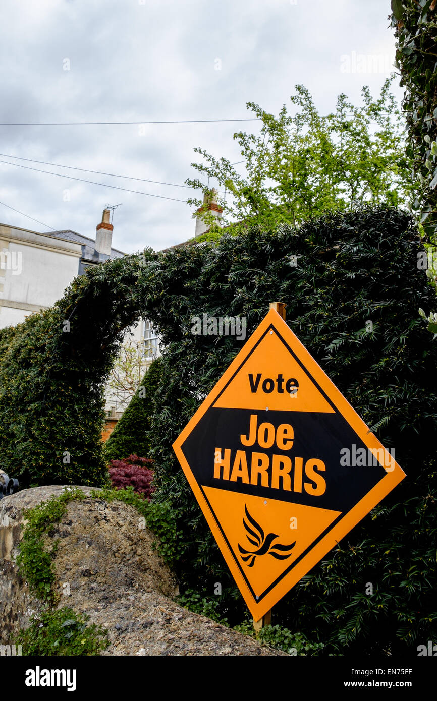 A Liberal Democrat banner urging the public to vote for the local candidate in Cirencester, UK, on the garden wall of a house Stock Photo