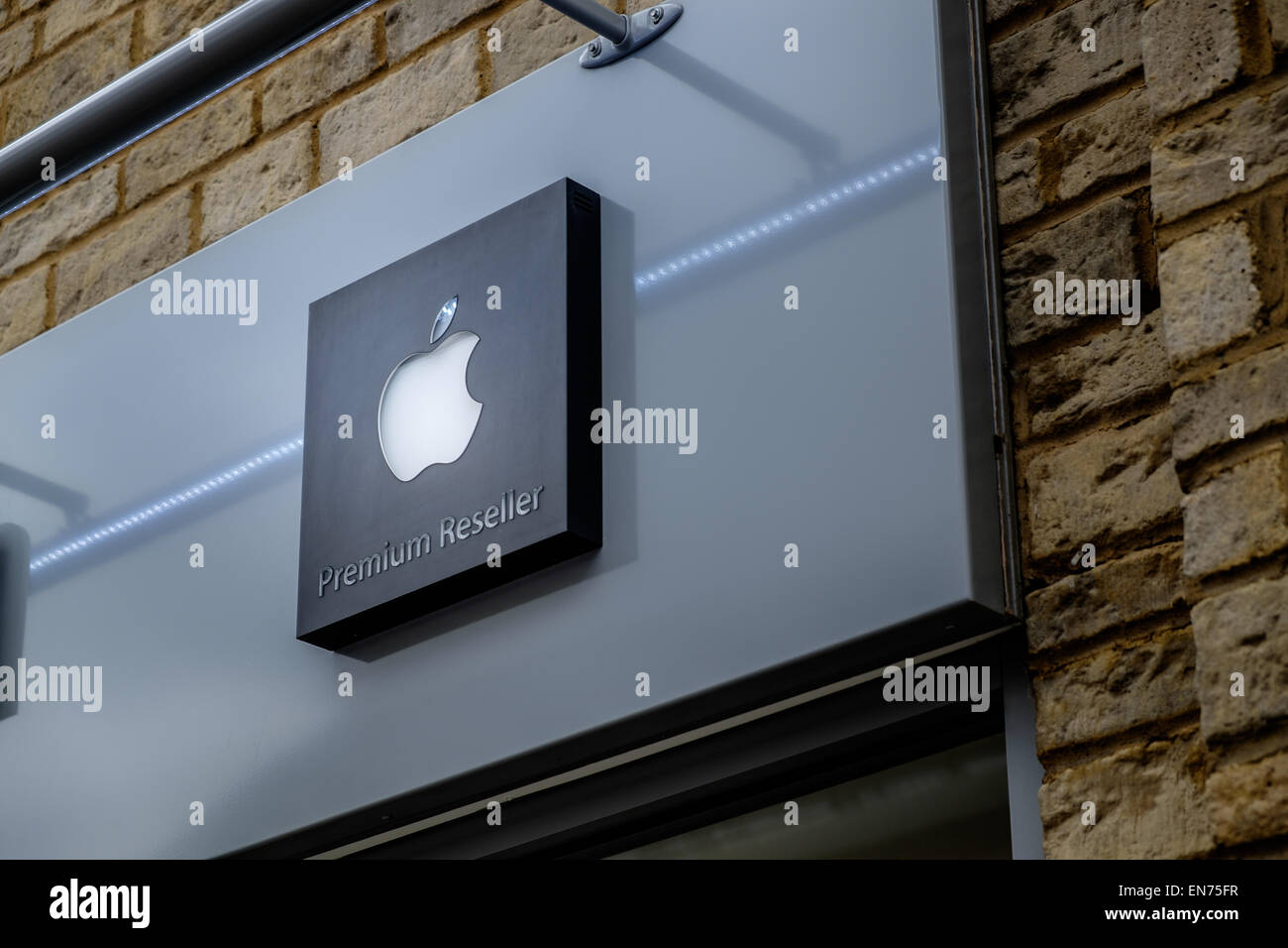 The trademarked trademark Apple logo on the sign of a Premium Reseller authorised authorized Macintosh Mac store shop exterior Stock Photo
