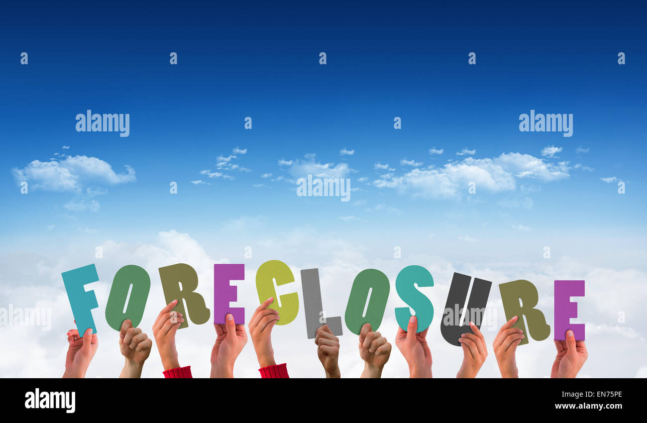 Composite image of hands holding up foreclosure Stock Photo