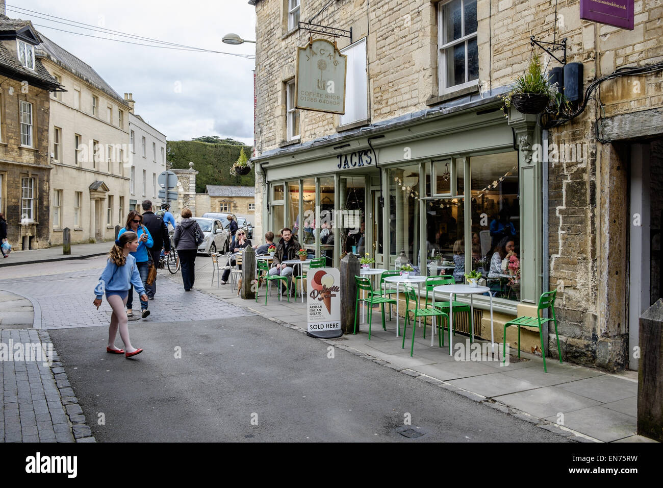 A child walks past Jack's Coffee House in Cirencester, Gloucestershire, UK. There are tables and chairs outside Stock Photo