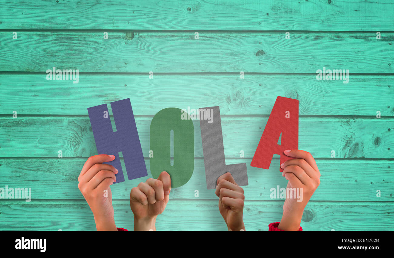Composite image of hands holding up hola Stock Photo