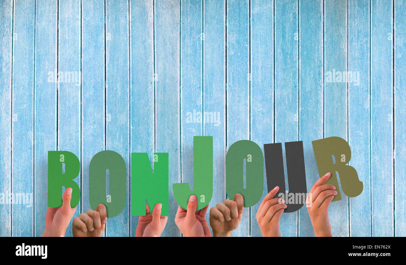 Composite image of hands holding up bonjour Stock Photo