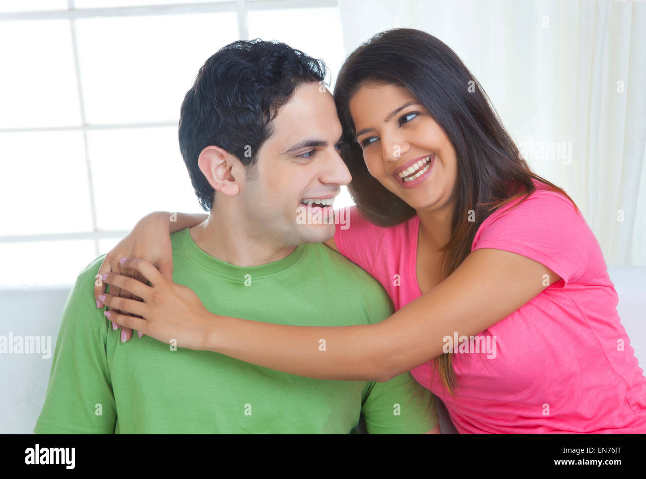 Young couple with arms around each other hi-res stock photography and ...