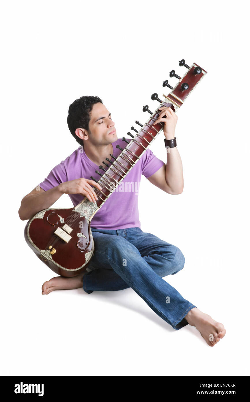 Young man playing the sitar Stock Photo