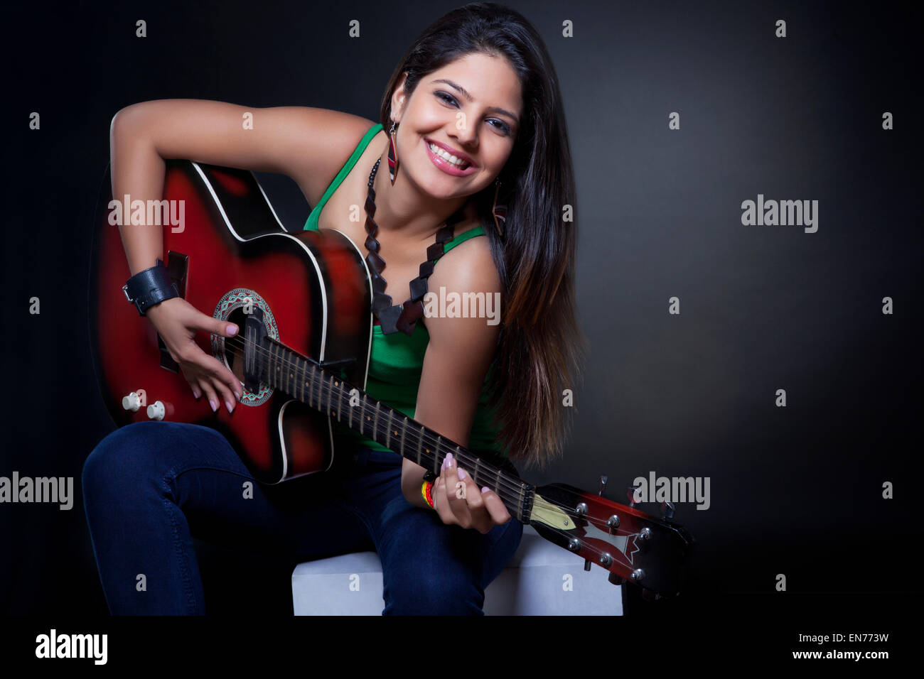 Young woman playing the guitar Stock Photo - Alamy