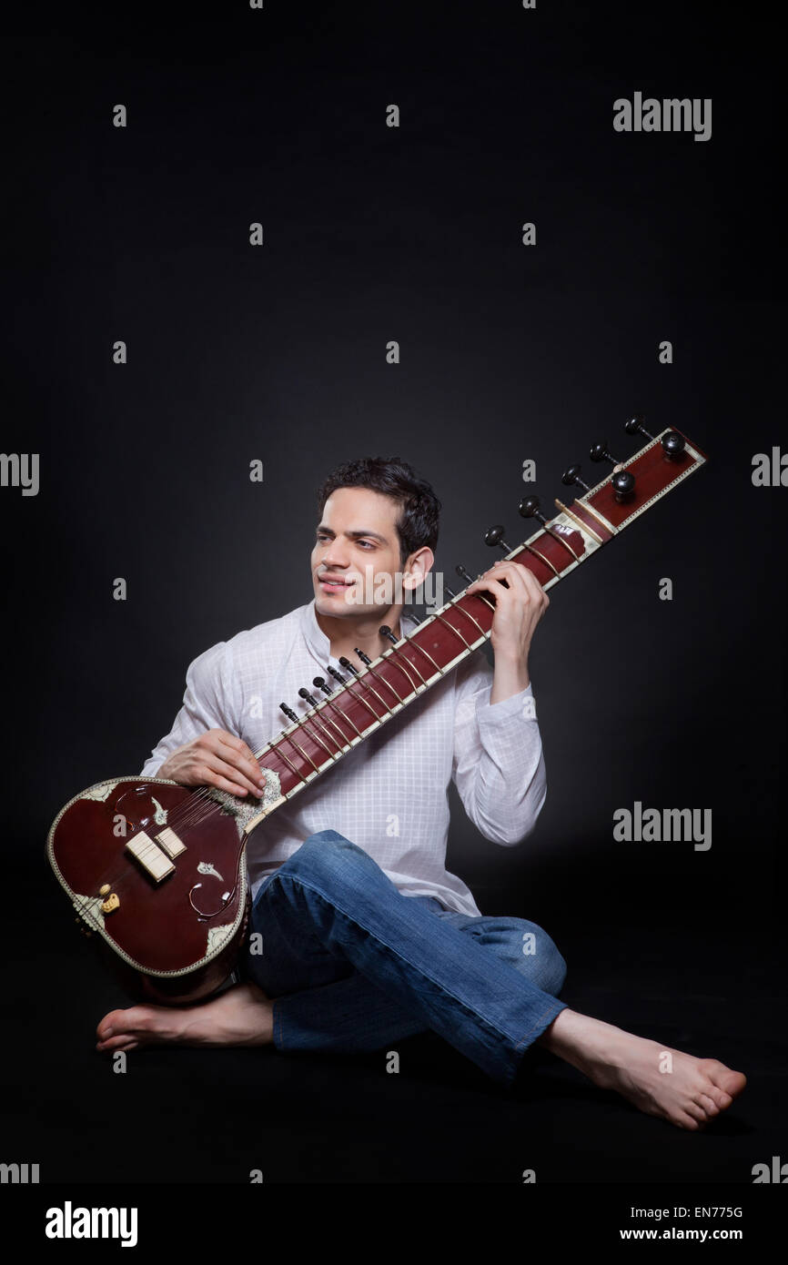 Young man playing the sitar Stock Photo Alamy