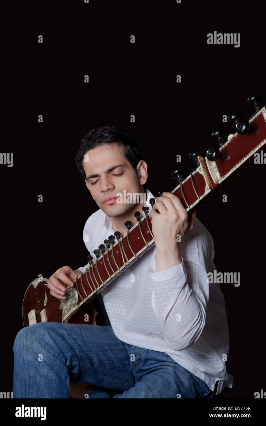 Young man playing the sitar Stock Photo Alamy