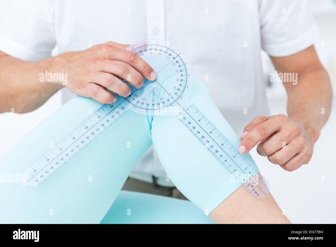 Doctor measuring knee with goniometer Stock Photo