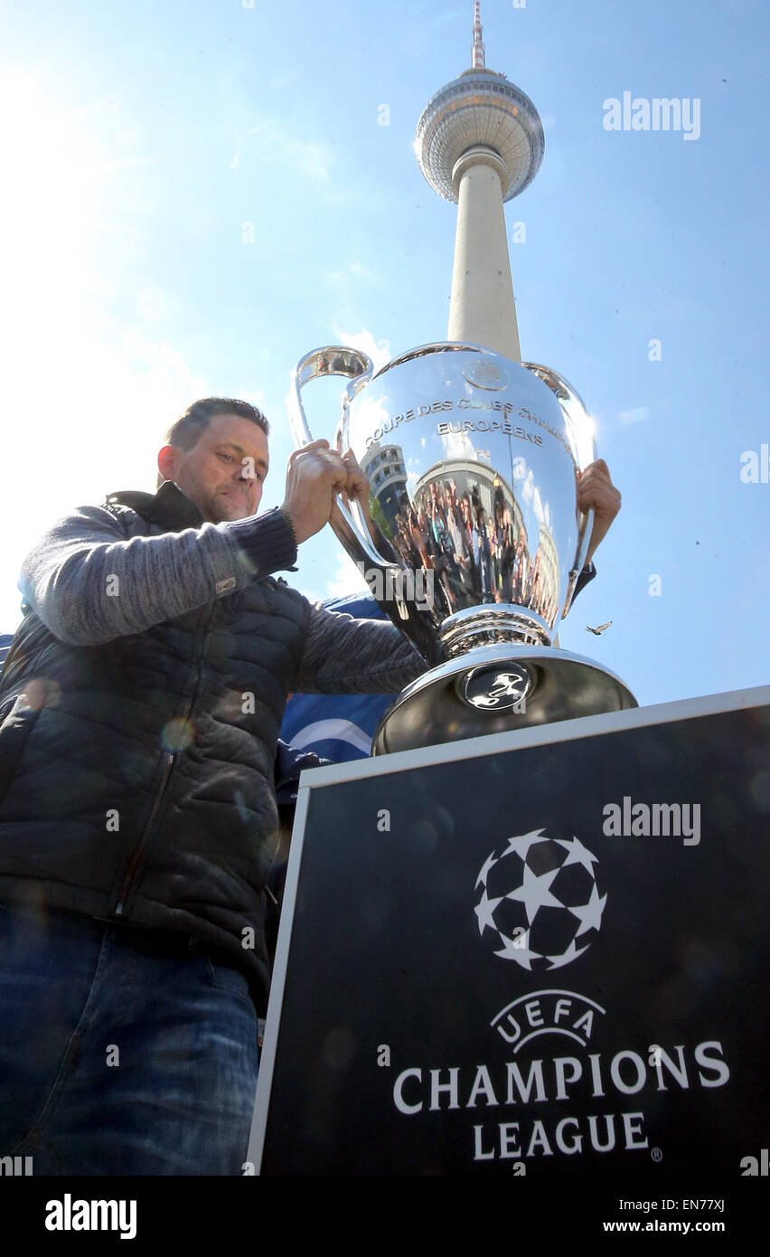 Berlin, Germany. 19th Apr, 2015. Host Matthias Killing puts down the trophy during the UEFA Champions League Trophy Tour in front of the TV Tower in Berlin, Germany, 19 April 2015. The Champions League final will take place in Berlin on 06 June 2015. Credit:  dpa picture alliance/Alamy Live News Stock Photo