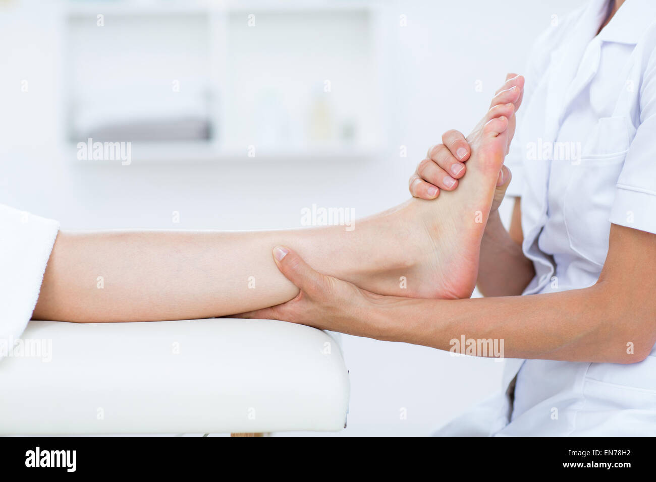 Physiotherapist doing foot massage Stock Photo