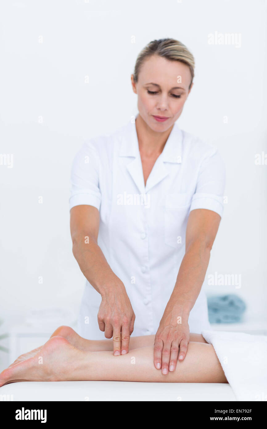 Physiotherapist doing leg massage Stock Photo