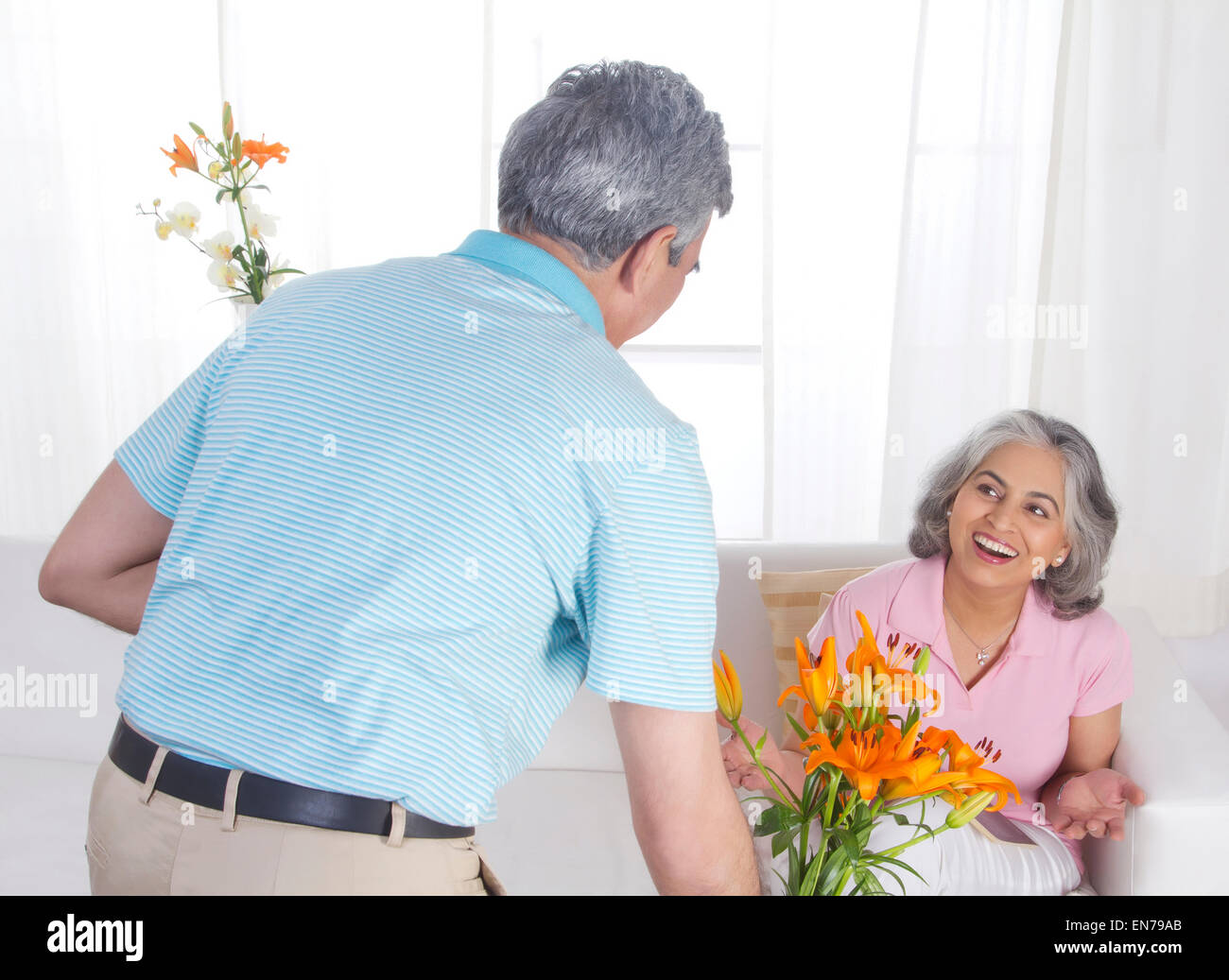 Husband giving flowers to his wife Stock Photo Alamy