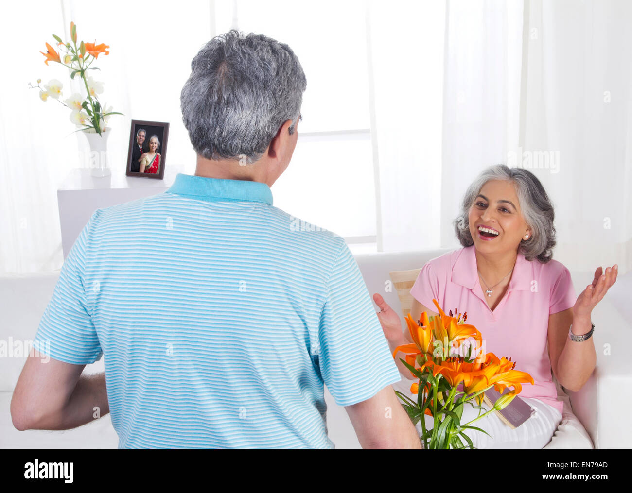Husband giving flowers to his wife Stock Photo Alamy