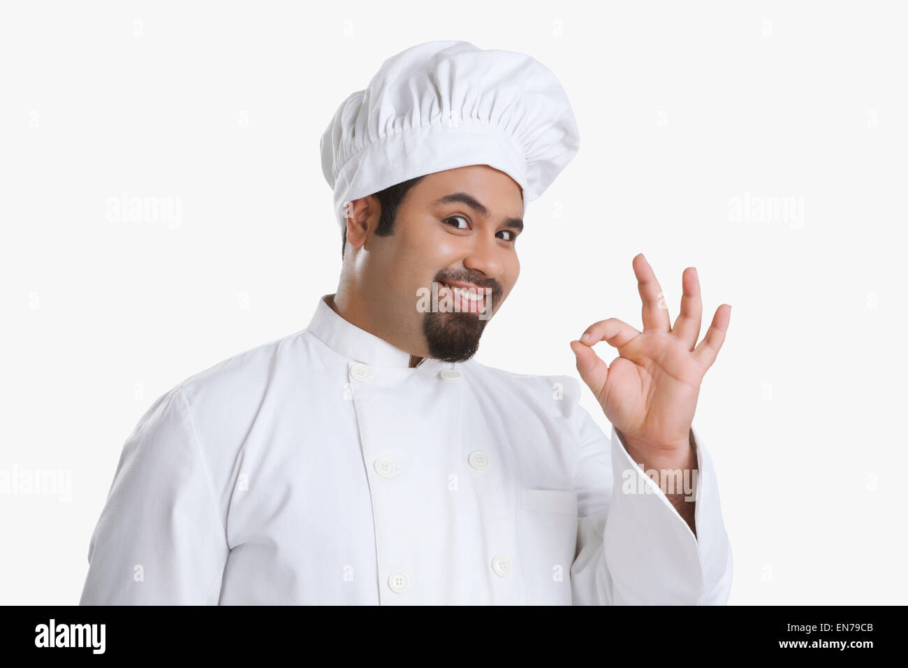Portrait of chef giving ok hand gesture Stock Photo