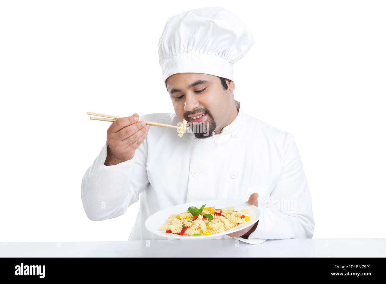 Chef eating pasta with chopsticks Stock Photo