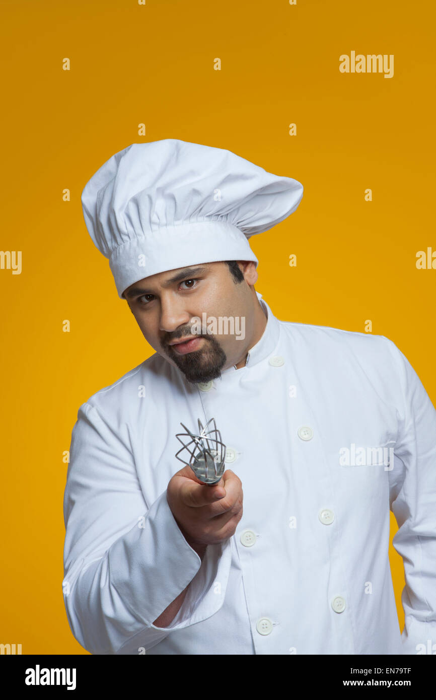 Portrait of chef holding wire whisk Stock Photo