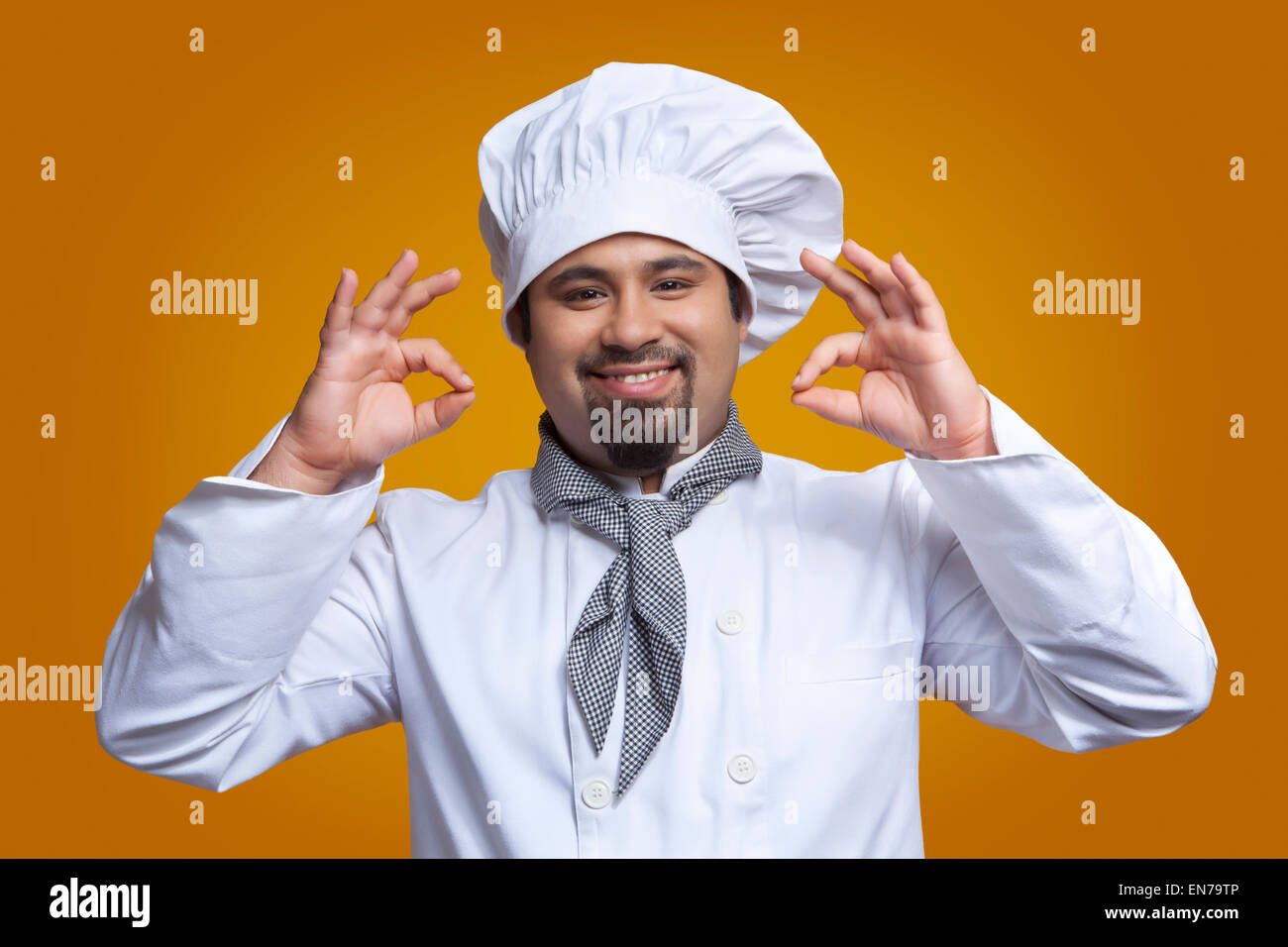 Portrait of chef giving ok hand gesture Stock Photo