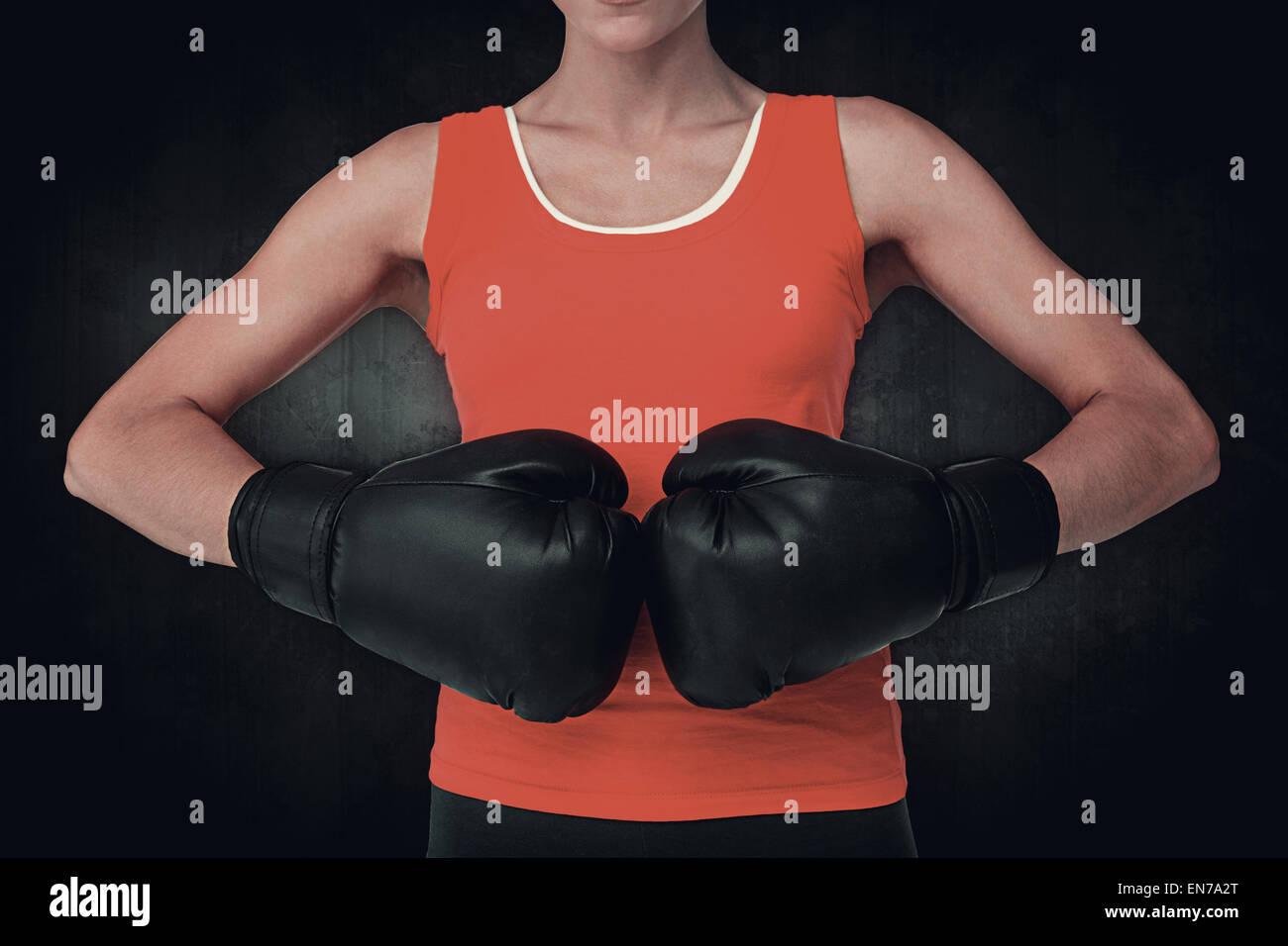 Composite image of close-up mid section of a determined female boxer ...